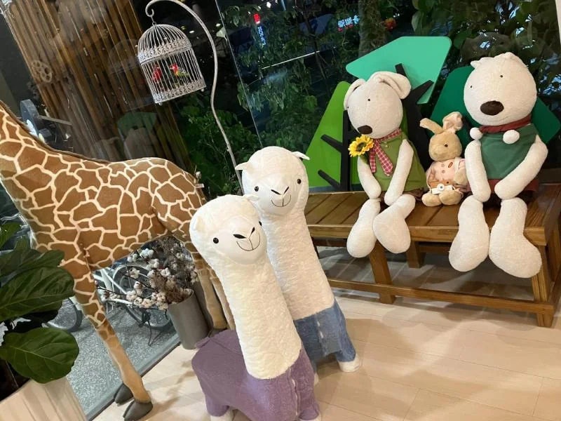 晟品公共角落的長頸鹿、羊駝與兔子玩偶及植栽
